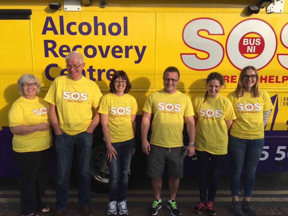 SOS Bus NI volunteers standing in front of the bus